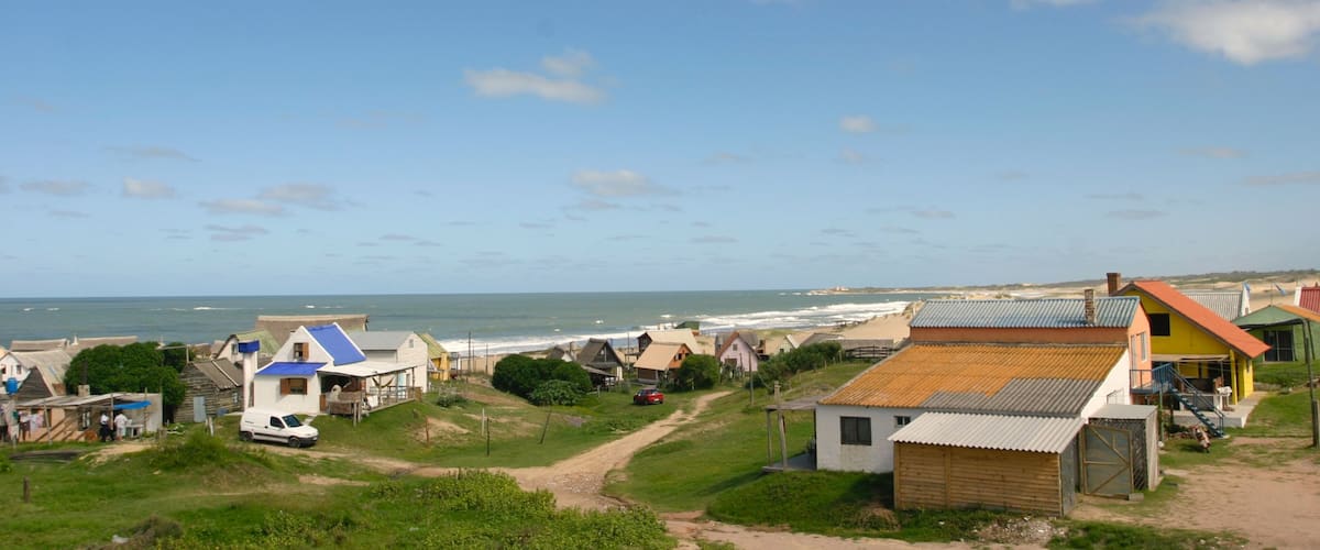 Punta del Diablo which includes a house and a coastal town