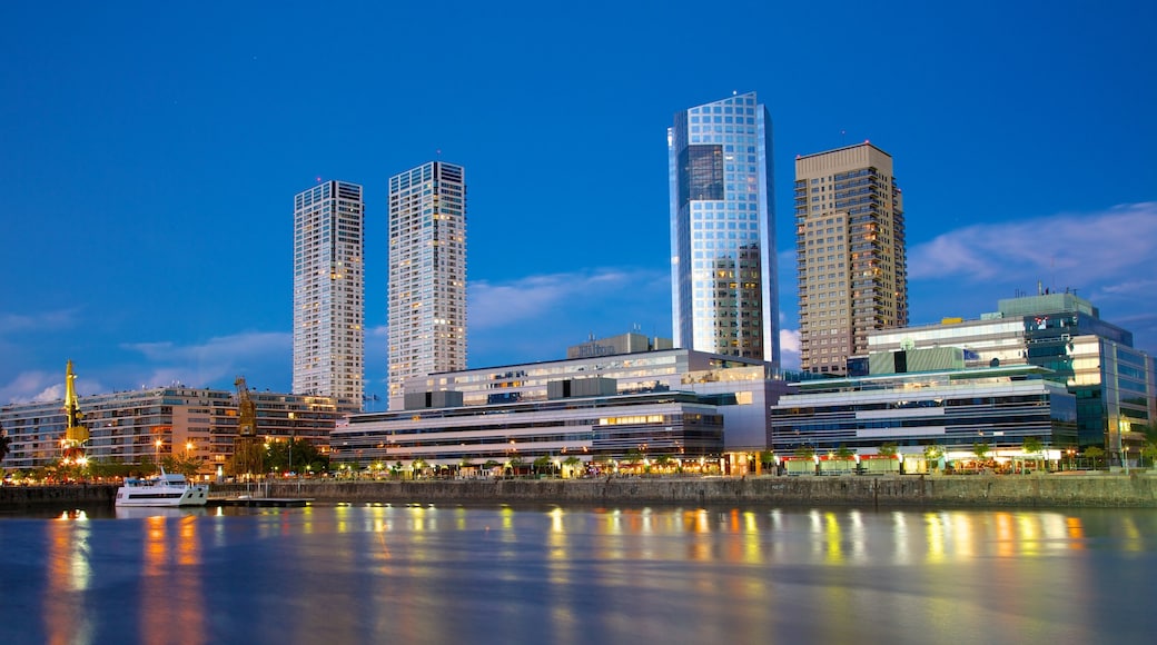 Puerto Madero which includes modern architecture, night scenes and a city