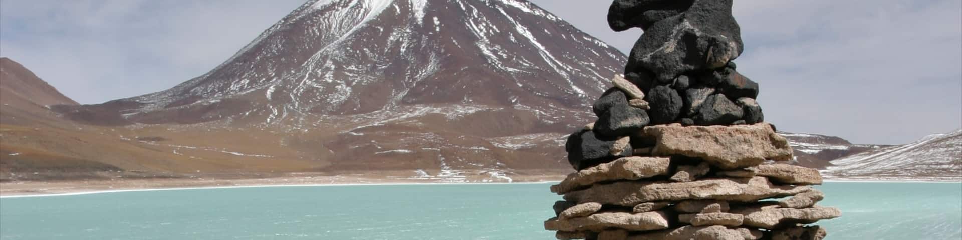 Bolivia showing a lake or waterhole, snow and mountains