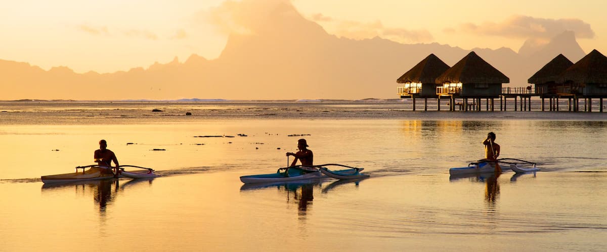 Tahiti showing general coastal views, a sunset and kayaking or canoeing