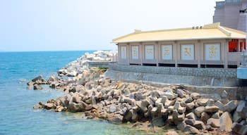 Guanyin Statue of Hainan showing rocky coastline