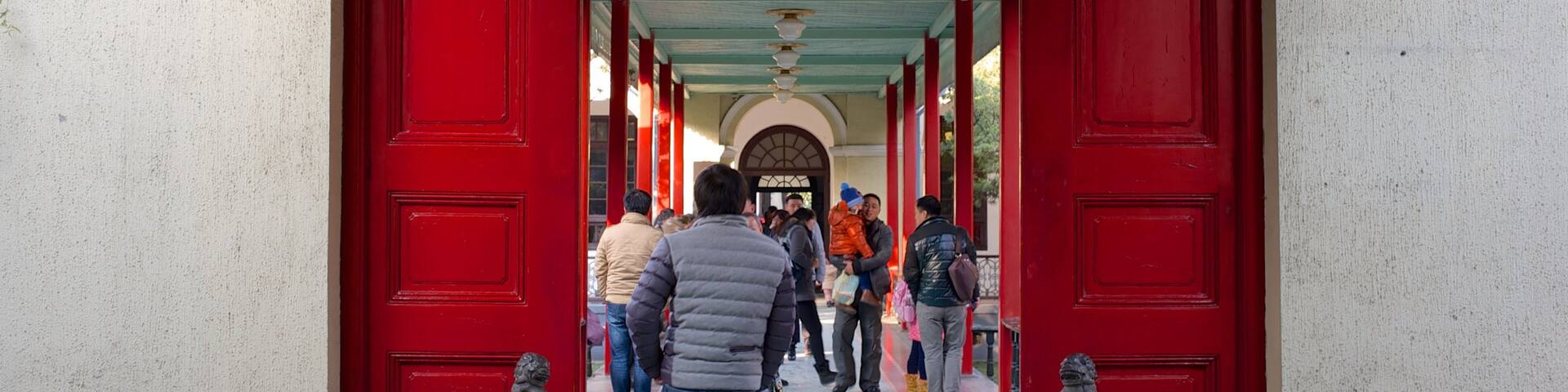 Nanjing Presidential Palace showing a castle and heritage architecture as well as a small group of people