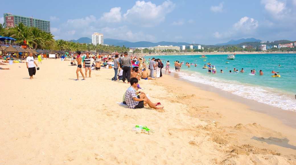 Dadongdai Beach featuring a sandy beach as well as a large group of people