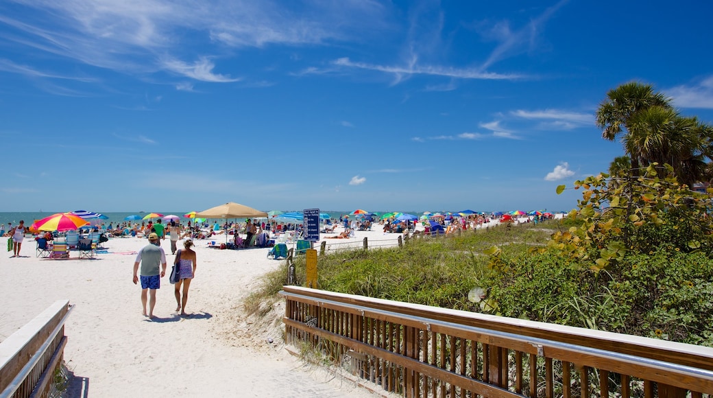 Fort Myers Beach showing a beach as well as a small group of people