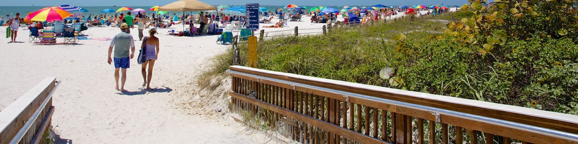 Fort Myers Beach showing a sandy beach as well as a small group of people