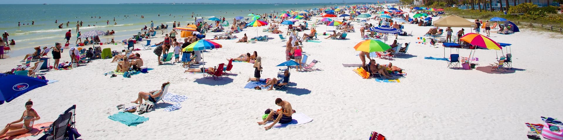 Fort Myers Beach featuring a sandy beach as well as a large group of people
