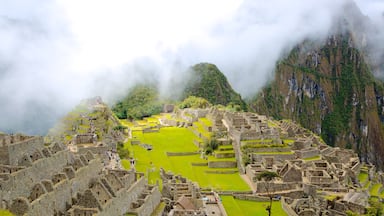 Machu Picchu showing mist or fog and a ruin