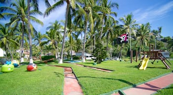 Manzanillo featuring tropical scenes, a playground and a garden