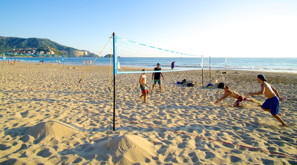 El Palmar Beach featuring a sandy beach and general coastal views as well as a small group of people