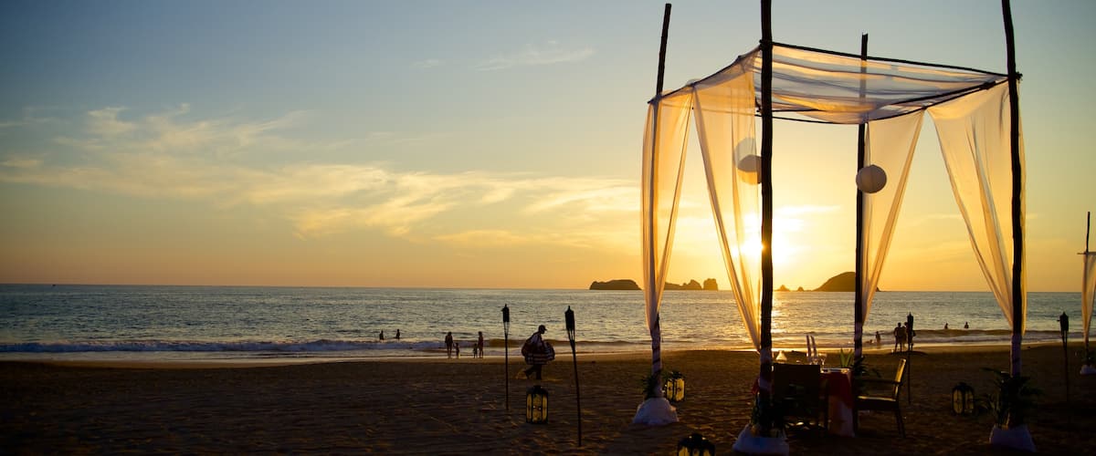 El Palmar Beach which includes tropical scenes, a sunset and a beach