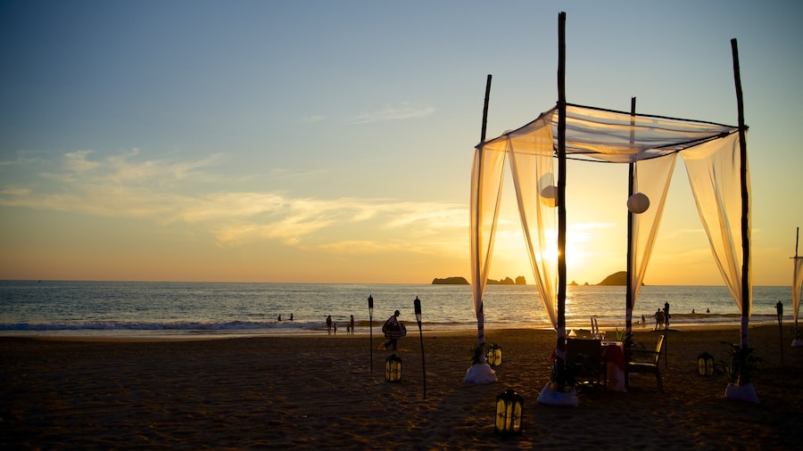 El Palmar Beach which includes tropical scenes, a sunset and a beach
