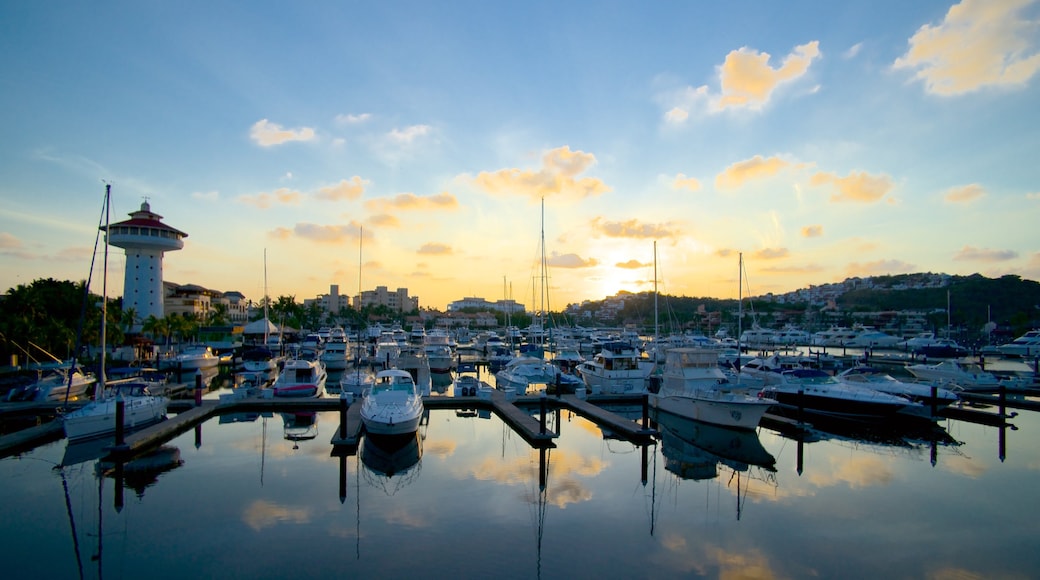 Marina Ixtapa featuring a sunset and a marina