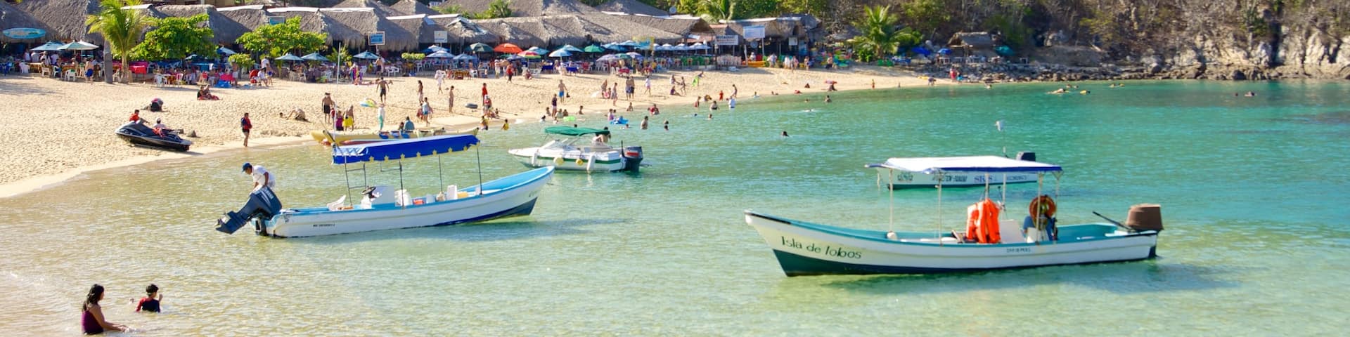 La Entrega Beach which includes a luxury hotel or resort, boating and general coastal views