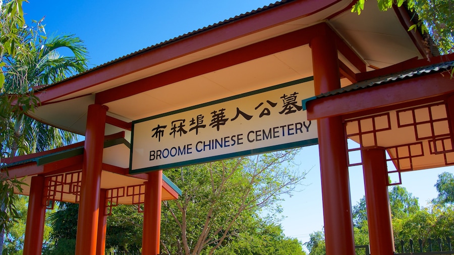 Broome featuring signage, a cemetery and religious elements