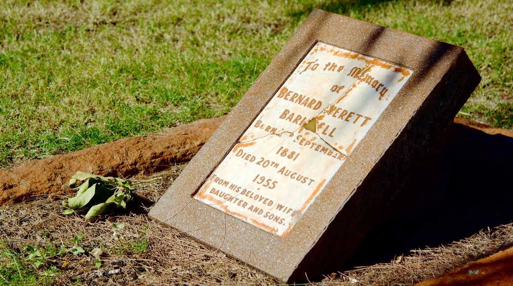 Town Beach showing a memorial, signage and a cemetery