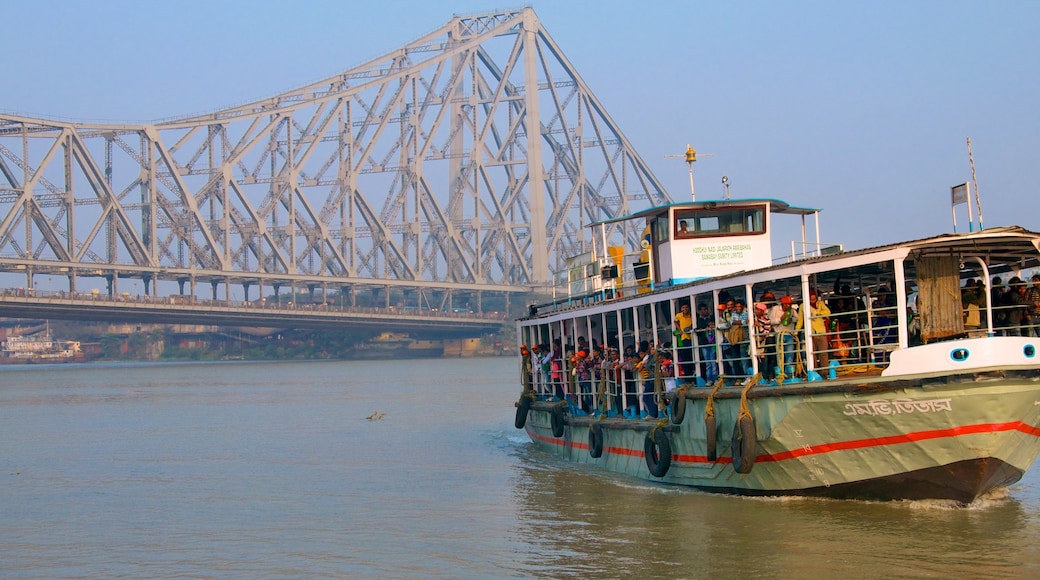 Howrah Bridge featuring a bridge, boating and general coastal views