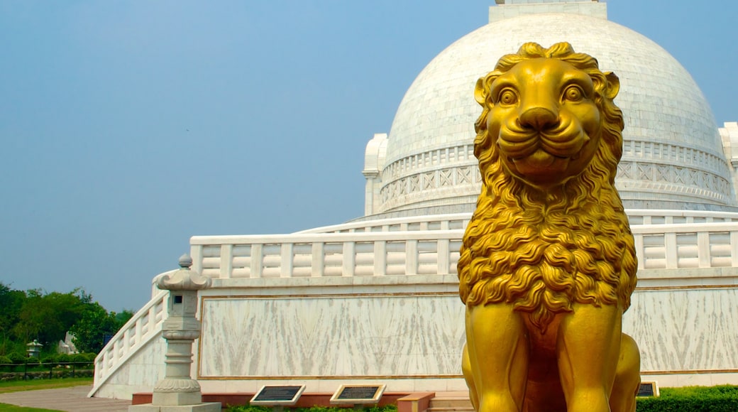 Lotus Temple featuring a statue or sculpture, a temple or place of worship and outdoor art