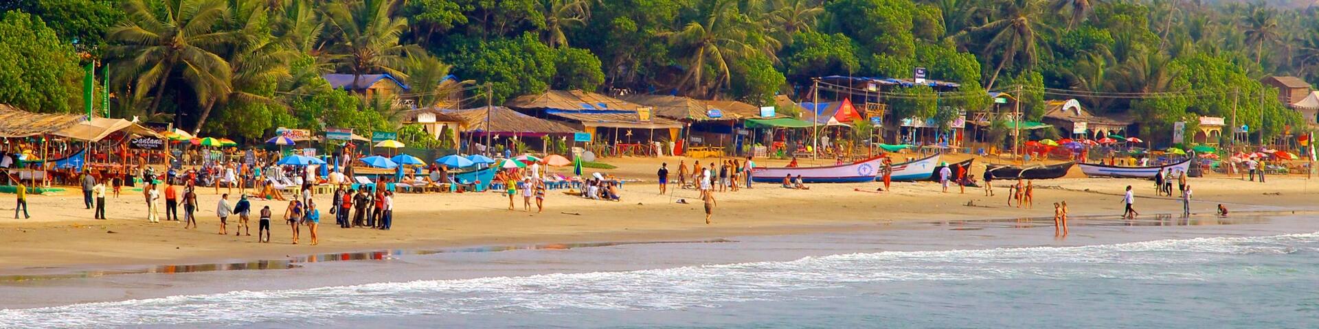 Arambol Beach which includes a coastal town, a sandy beach and landscape views