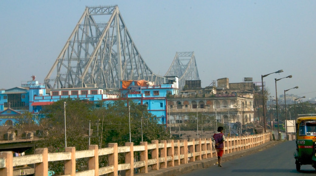 Howrah Bridge which includes street scenes, a city and a bridge