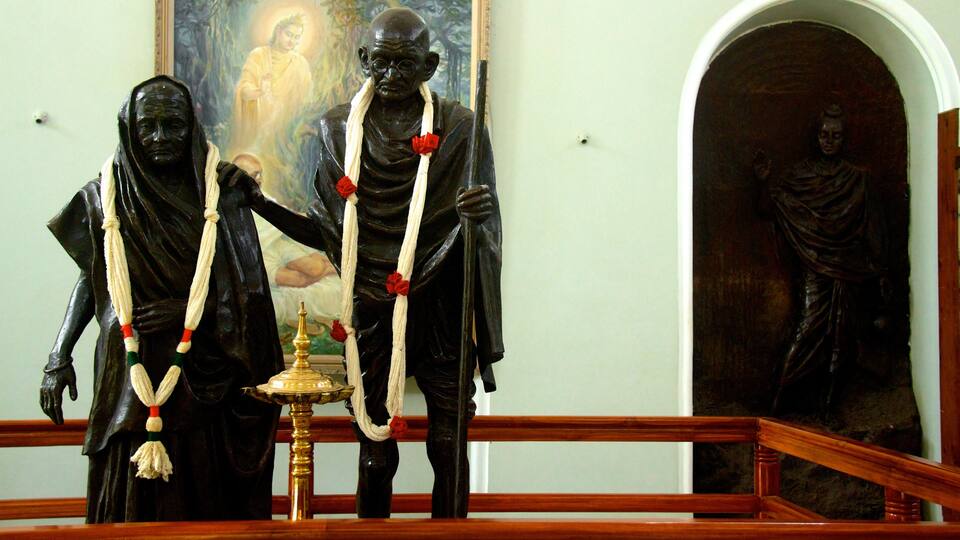 Aga Khan Palace featuring a statue or sculpture, château or palace and interior views