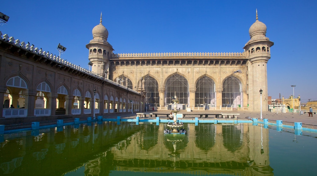 Mecca Masjid featuring a pond and a mosque