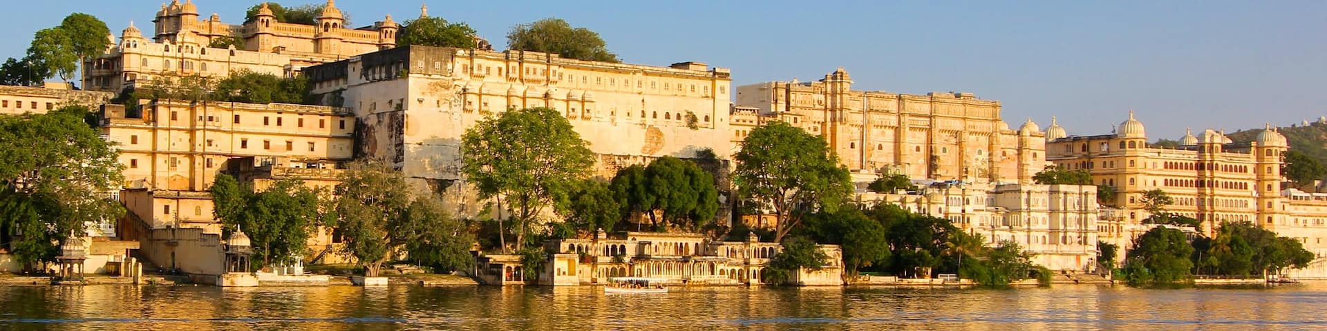 City Palace which includes a castle and a lake or waterhole