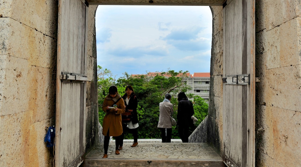 Shurijo Castle featuring heritage architecture and a castle as well as a small group of people