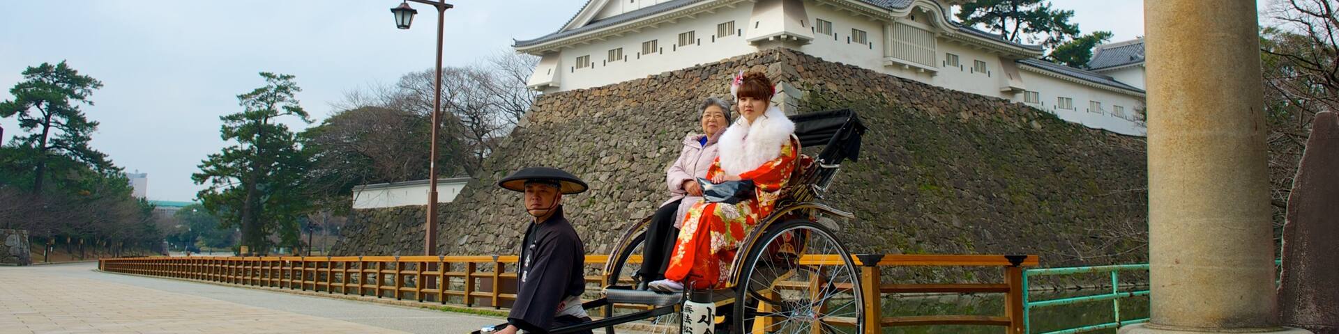 Kokura Castle which includes street scenes and a castle as well as a small group of people