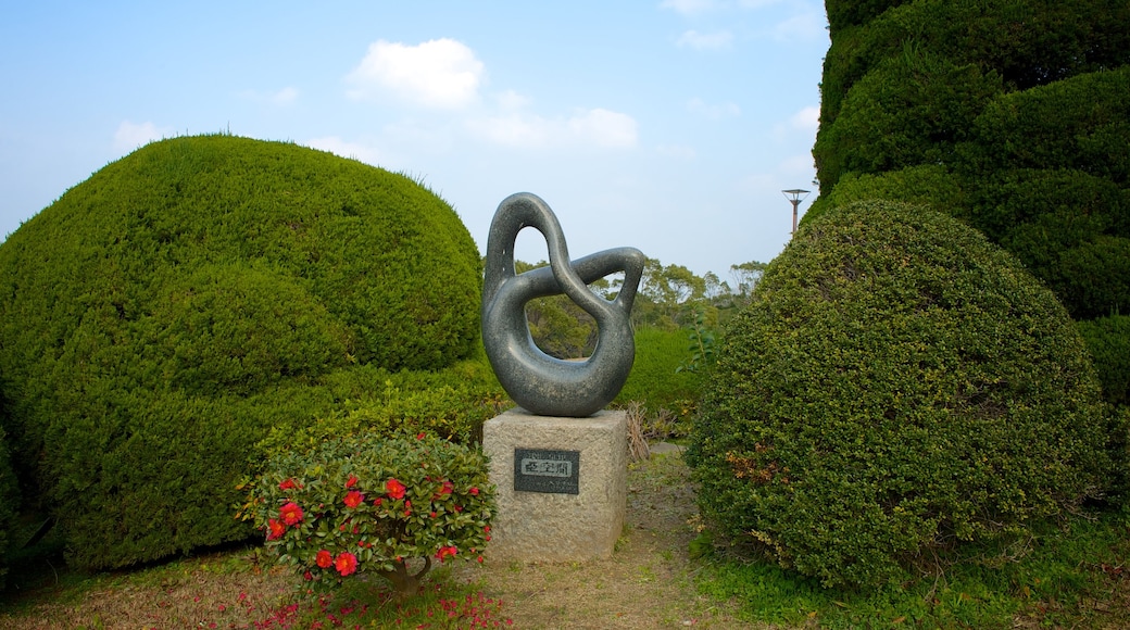 Kitakyushu City Art Museum featuring outdoor art, a park and flowers