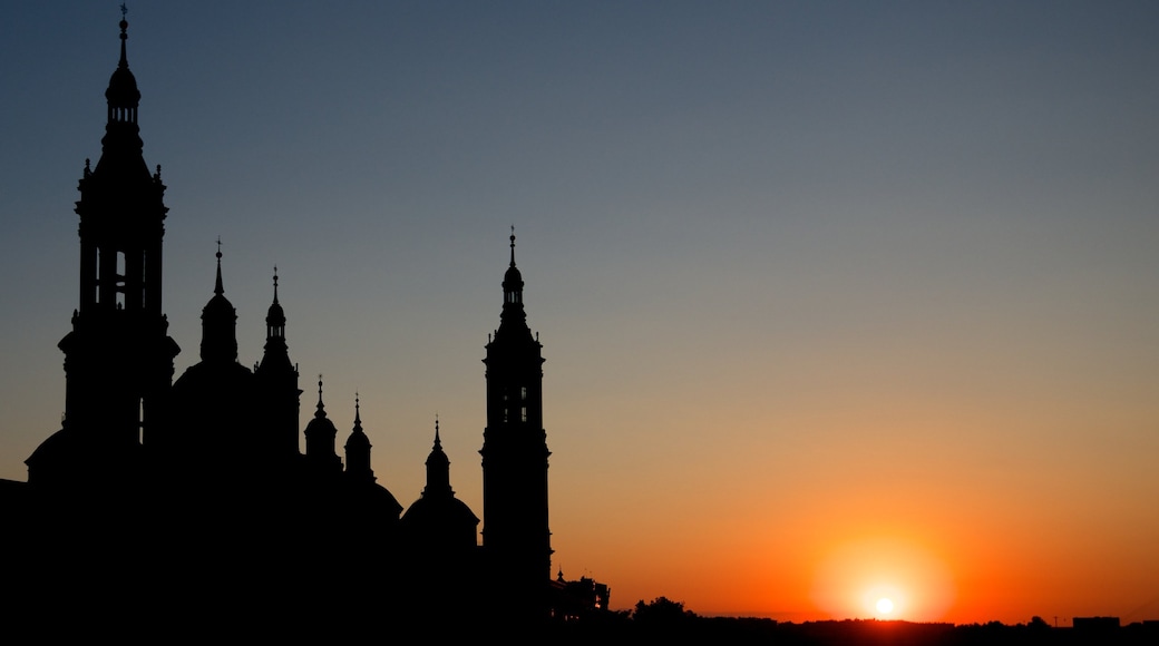 Zaragoza showing a church or cathedral, a sunset and heritage architecture