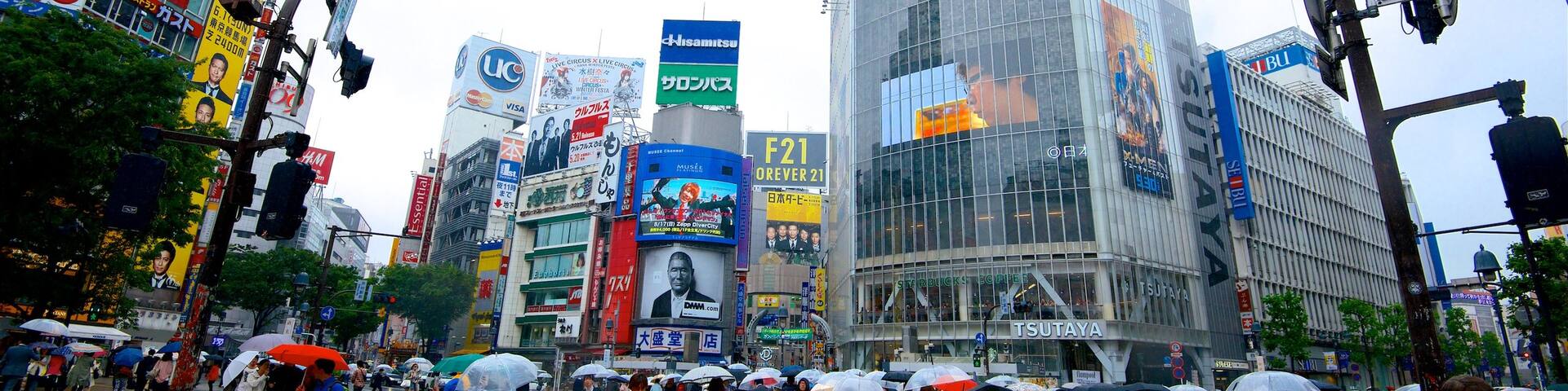 Shibuya Crossing featuring signage, street scenes and modern architecture