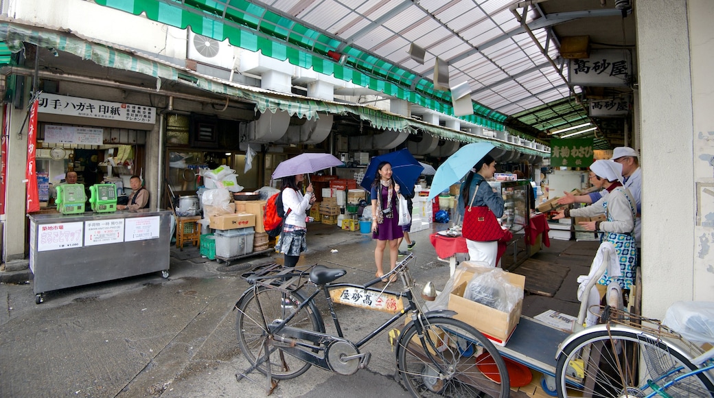 Tsukiji Fish Market showing markets, interior views and a city