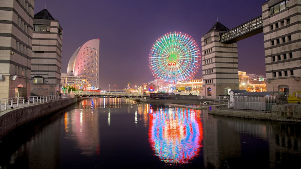 Minatomirai which includes night scenes, a city and central business district