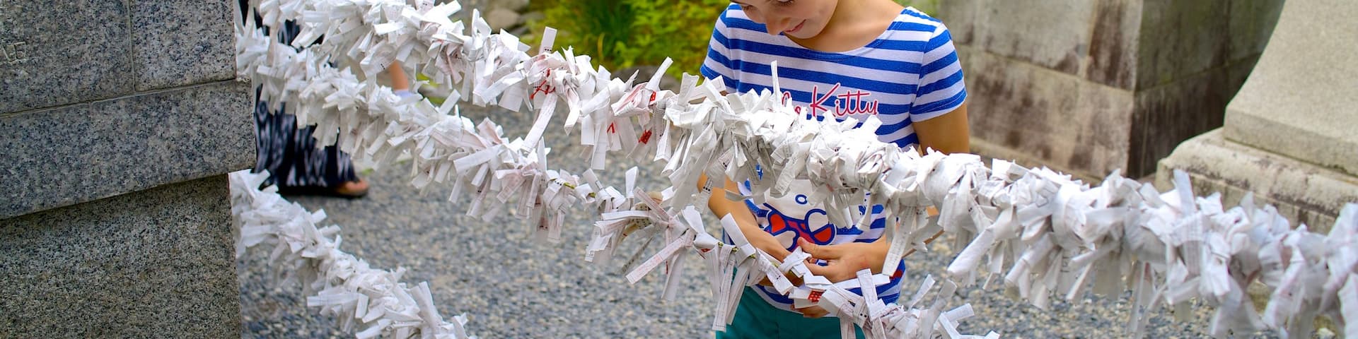 Fushimi Inari Shrine showing religious aspects as well as an individual child