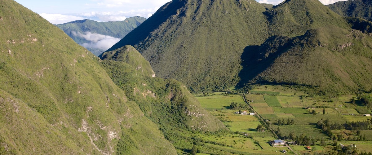 Quito featuring farmland, mountains and landscape views