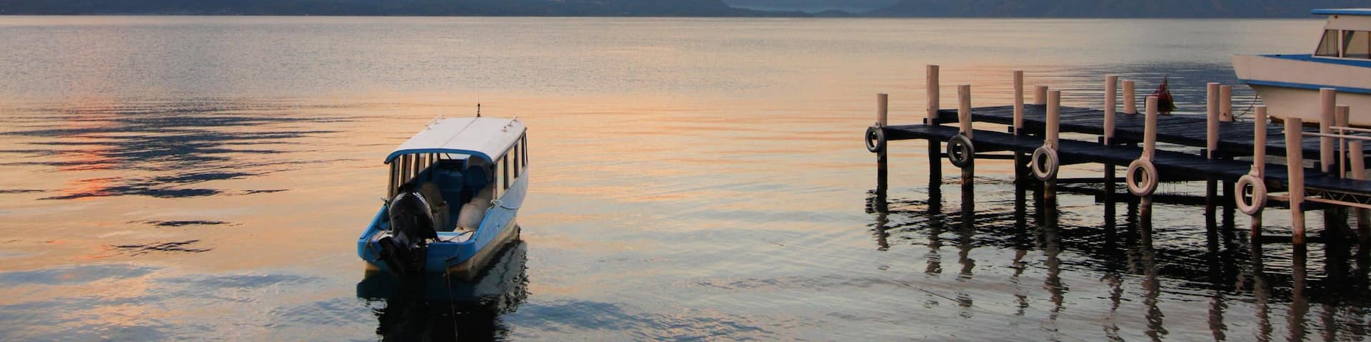 Lake Atitlan showing landscape views, a lake or waterhole and a sunset