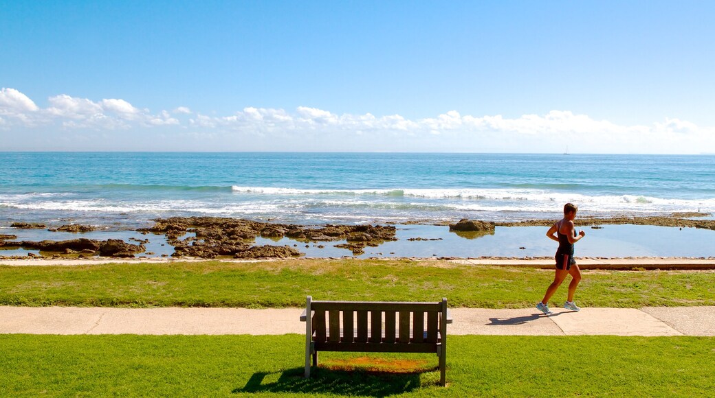 Hobie Beach showing general coastal views and landscape views as well as an individual femail