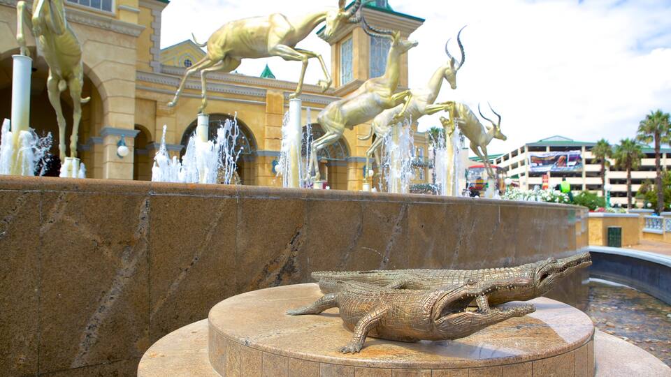 Gold Reef City featuring a fountain, art and a city