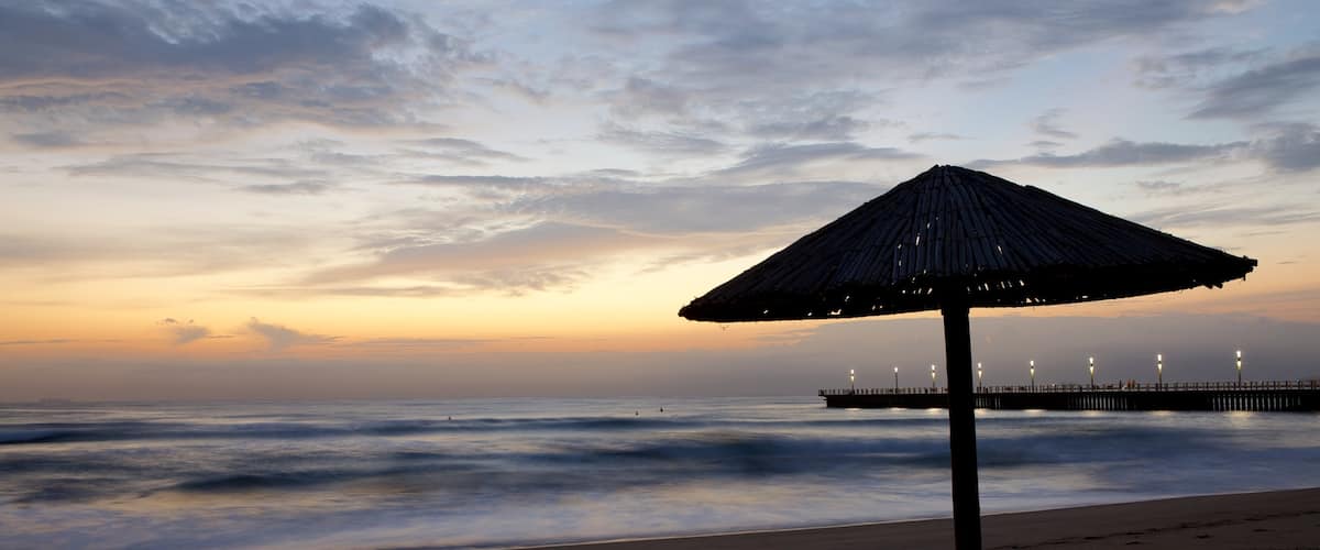 North Beach featuring a sunset and a beach