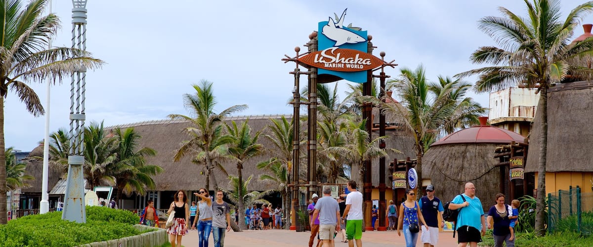 uShaka Marine World featuring signage and rides as well as a large group of people