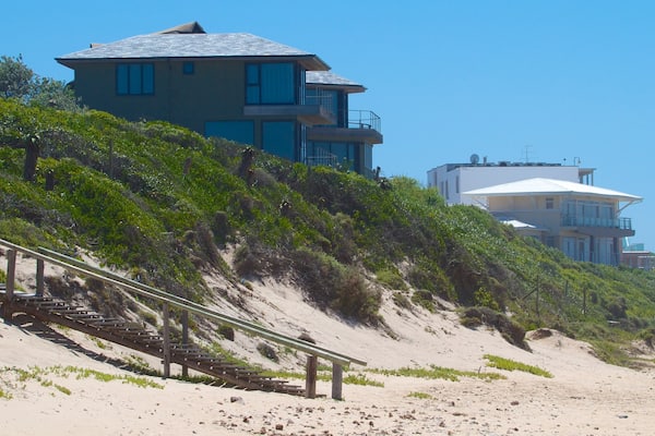 Dolphin Beach showing a coastal town, a house and a beach