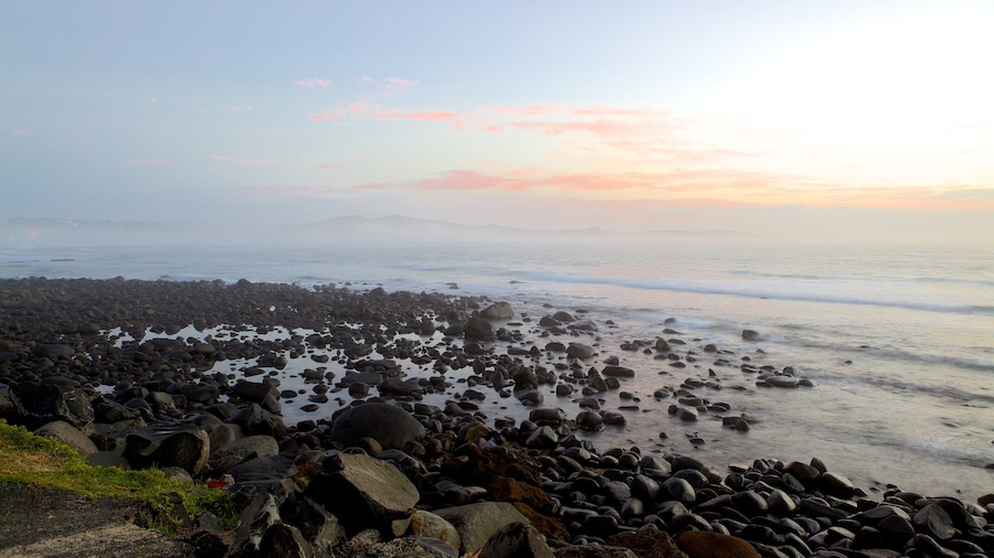 Nahoon Beach which includes landscape views, a sunset and a pebble beach