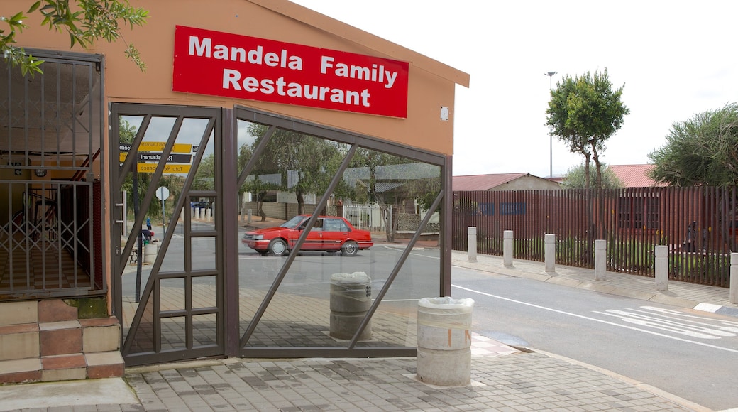 Mandela House showing a city, signage and street scenes