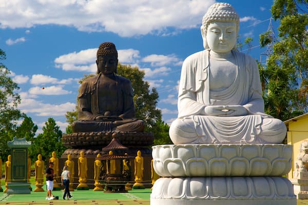 Buddhist Temple which includes a statue or sculpture, a temple or place of worship and religious elements
