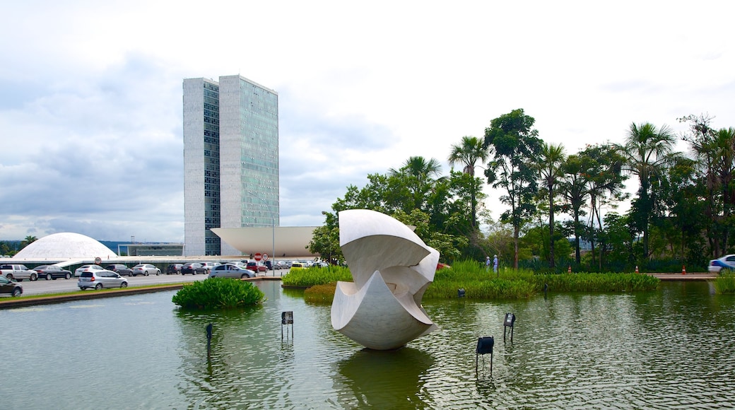 Itamaraty Palace which includes a high rise building, modern architecture and a pond