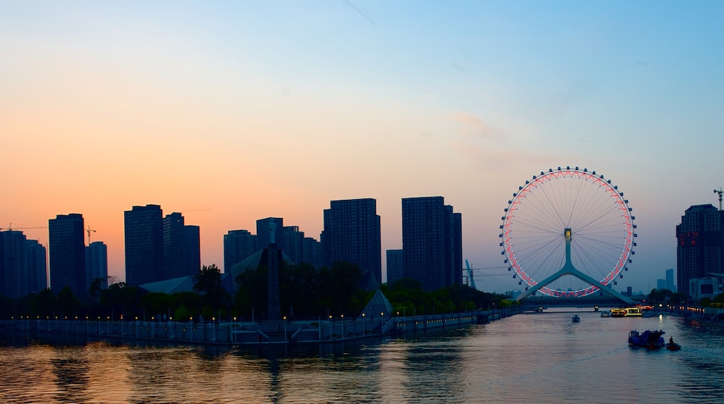 Tianjin Eye which includes skyline, a skyscraper and a river or creek