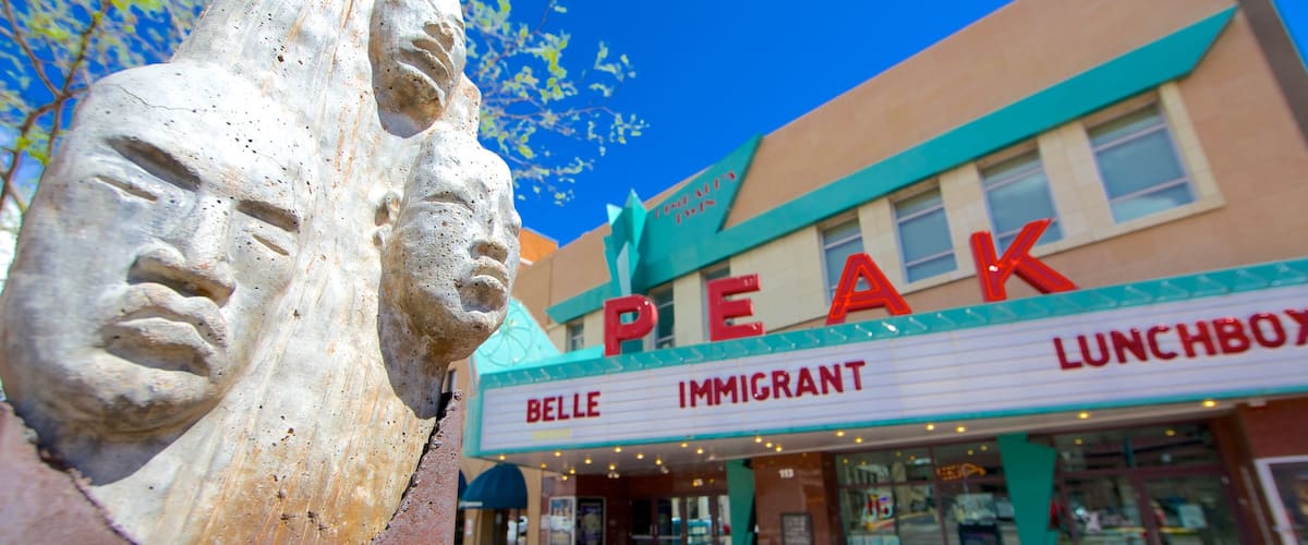 Downtown Colorado Springs featuring signage and a statue or sculpture