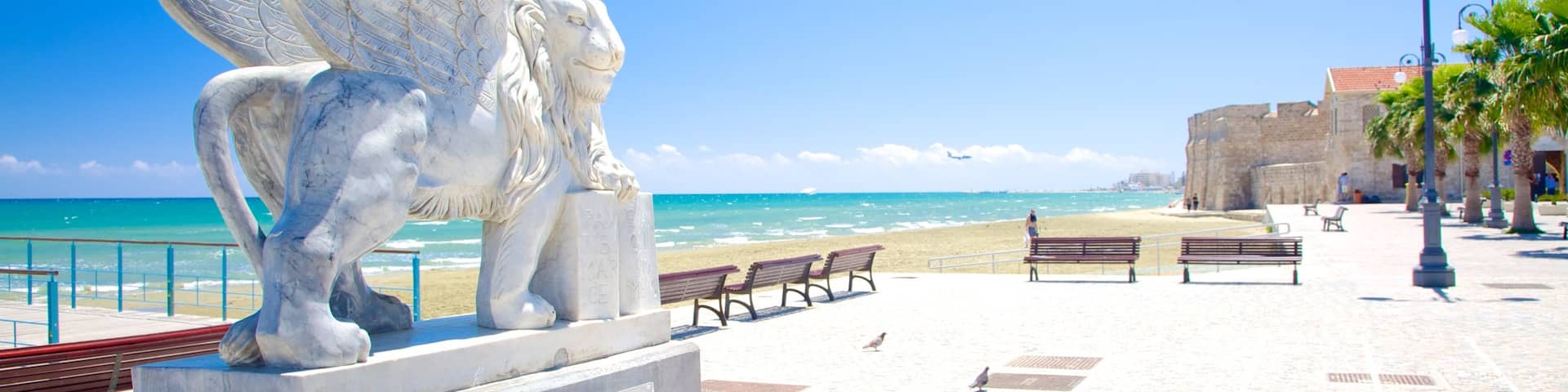 Finikoudes Beach which includes general coastal views and a statue or sculpture