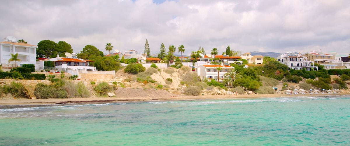 Coral Bay Beach which includes a bay or harbour, a coastal town and general coastal views