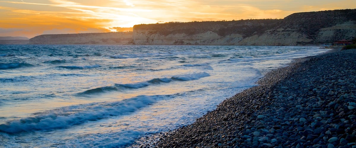 Limassol showing a pebble beach and a sunset